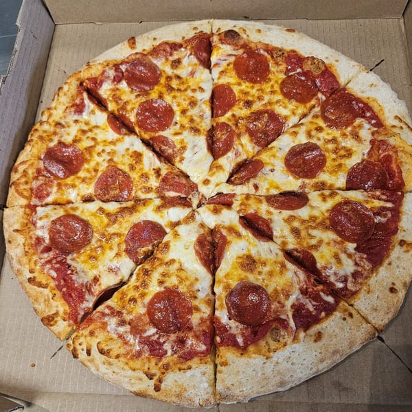 A whole pepperoni pizza from Big's Pizza and Subs, sliced into eight pieces in a cardboard box.